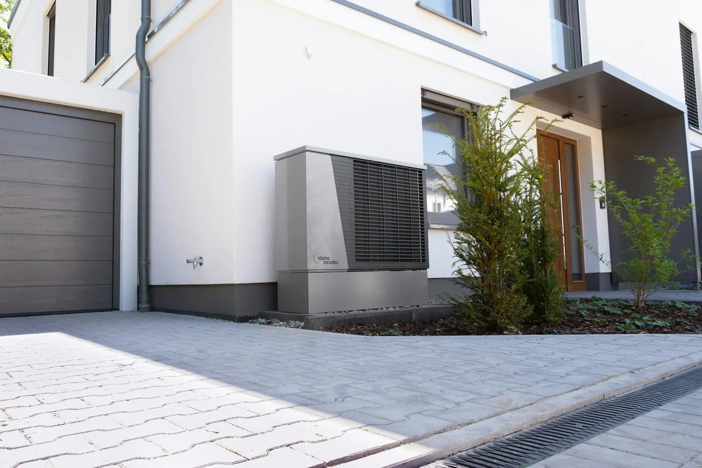 Energy-efficient heat pump hot water unit installed outside a modern home